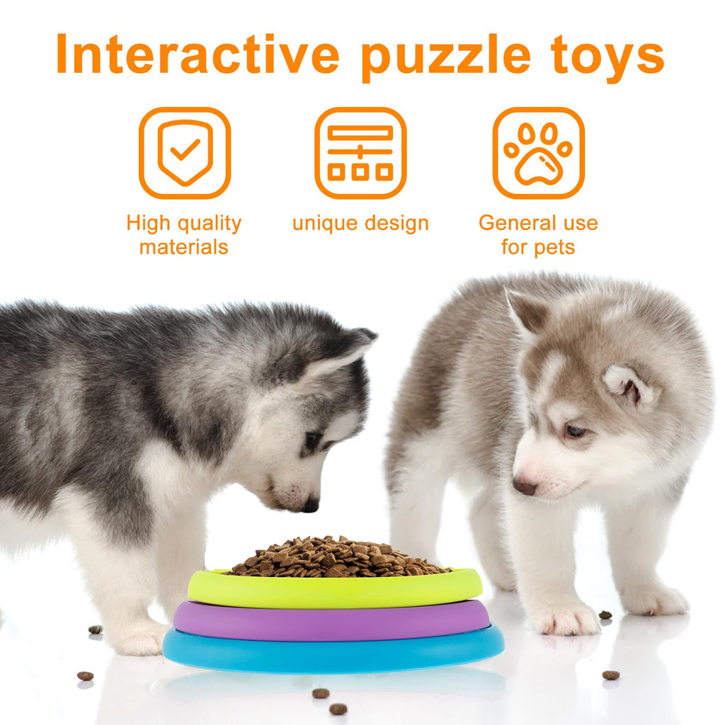 Two puppies using a colorful interactive slow feeder puzzle